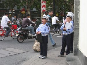 We saw these kids dressed up on the streets of Hnagzhou. They were counting cars or something and not actually doing law enforcement....I think. 
