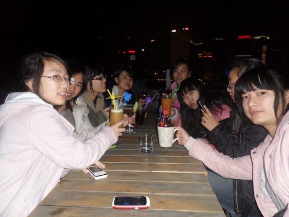A group of girls (all around 22-23 years of age) trying their first sips of alcohol at Captain's Bar in Shanghai. Some, who ordered sweet mixed drinks, enjoyed it, while others, like the girl who ordered straight gin, did not. 