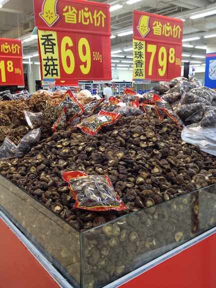 There are a lot more open bins in China, with everything from candy to beans to dried fruit. This is a bin of dried mushrooms you can pick at freely. 