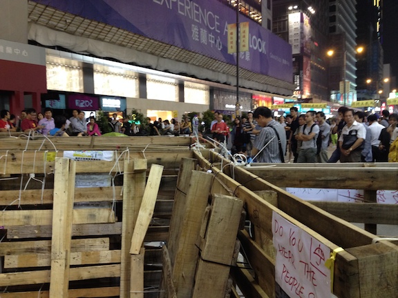 In Mong Kok the people erected barriers to prevent cars and buses (and the police) from being able to drive on the street. 